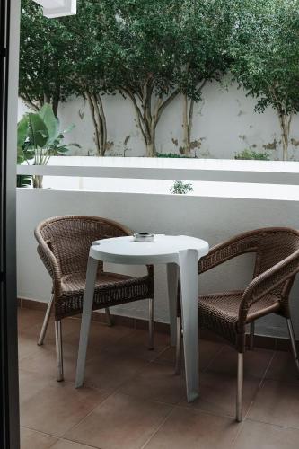 a white table and two chairs and a table and chairs at Carvi Beach Hotel in Lagos