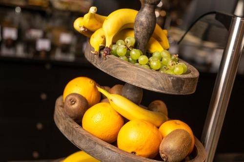 two baskets filled with fruit on a shelf at Hotel Alpina Luzern in Luzern