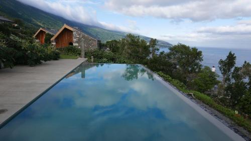 a swimming pool with a view of the ocean at Lava Homes in Santo Amaro