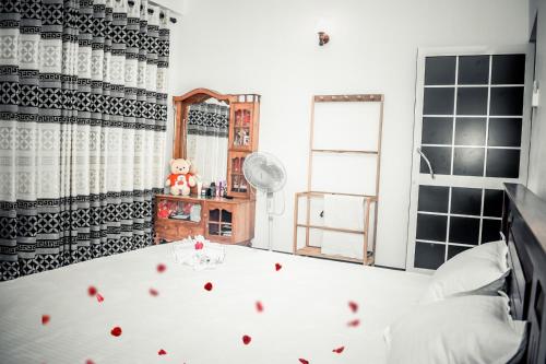 a bedroom with a bed with red hearts on it at Pearl Residence in Weligama