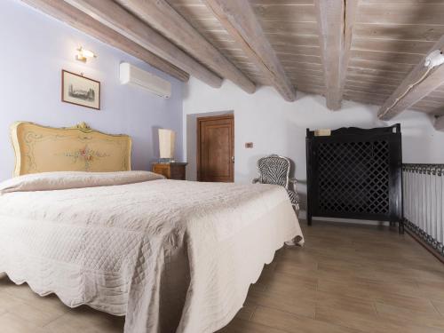 a bedroom with a large bed and a wooden ceiling at Antica Dimora San Girolamo in Licata