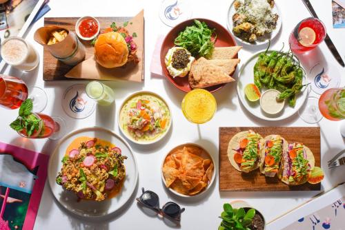 a table with many plates of food on it at The Pierside Santa Monica in Los Angeles
