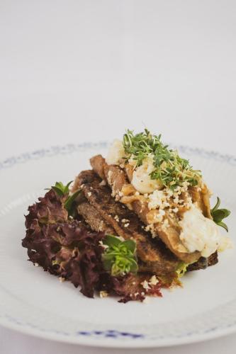 a plate of food with meat and vegetables on it at Schackenborg Slotskro in Tønder