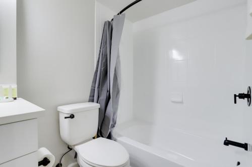 a bathroom with a toilet and a tub and a sink at Modern & Charming Apt With Rooftop @pentagon City in Arlington