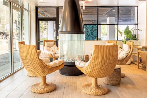 a living room with two chairs and a large aquarium at The Pierside Santa Monica in Los Angeles
