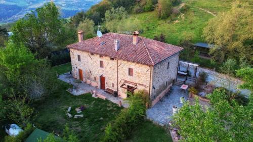 an aerial view of a large stone house on a hill at Raggio Campacci di Sacchetti Vanessa in Rovereti