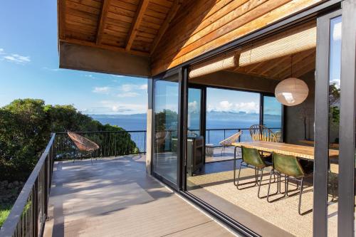 a patio with a table and chairs on a balcony at Lava Homes in Santo Amaro