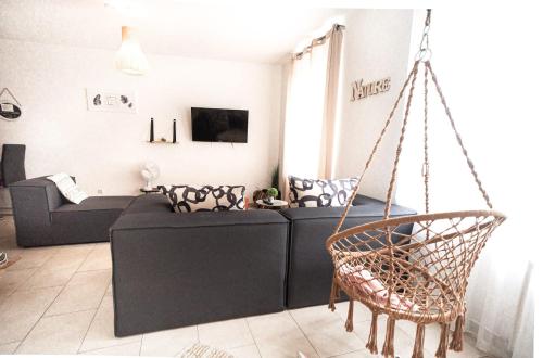a living room with a couch and a swing at Holiday Home Leonie in Bollendorf