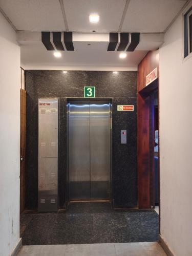 a elevator in a building with the number six at HOTEL A.K.INTERNATIONAL INN in Ullāl