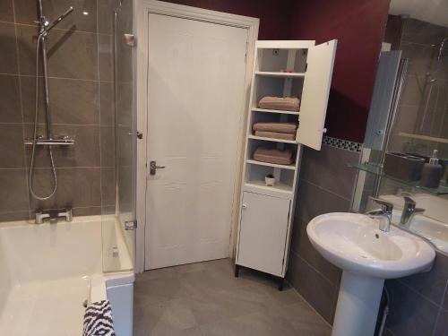 a bathroom with a sink and a toilet and a shower at cleethorpes seaside garden apartment in Cleethorpes