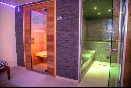 シス・フール・レ・プラージュにあるLove room - Spa balnéo - Hammam sauna -Emmy Éléganceのガラスドア付きのシャワーが備わります。