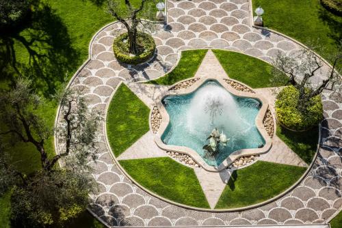 an overhead view of a pool in a garden at Rome Cavalieri, A Waldorf Astoria Hotel in Rome