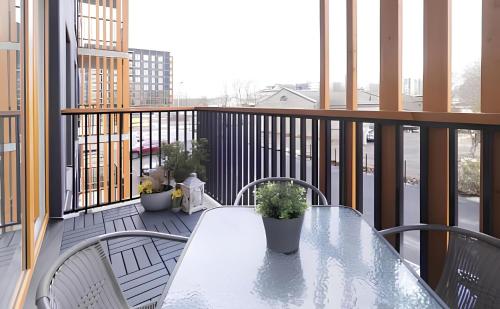 a balcony with a table and chairs and windows at 7th floor Tallinn in Iru