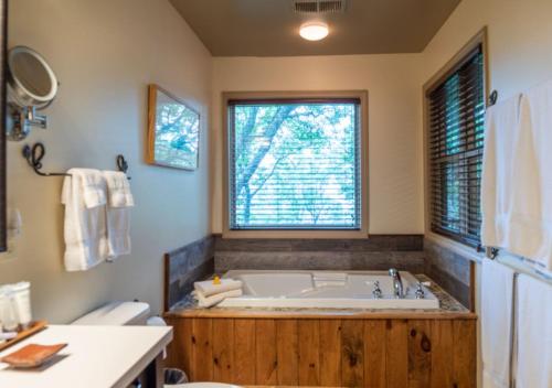 a bathroom with a large tub and a window at Snowbird Mountain Lodge in Robbinsville