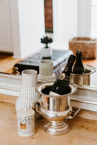 a metal bucket with a bottle of champagne in it at Yarranvale on Gladstone - A Gorgeous Country Abode in Mudgee