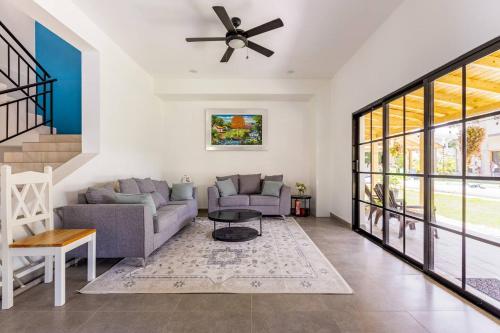 a living room with a couch and a ceiling fan at Villas Elim A and B in Cabrera