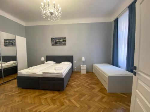 a bedroom with two beds and a chandelier at Top class apartments in Carlsbad Bulharska street in Karlovy Vary