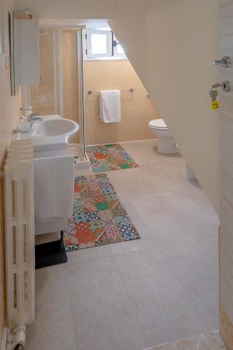 a bathroom with a sink and a toilet and a shower at Affittacamere SS. Smile in Loreto