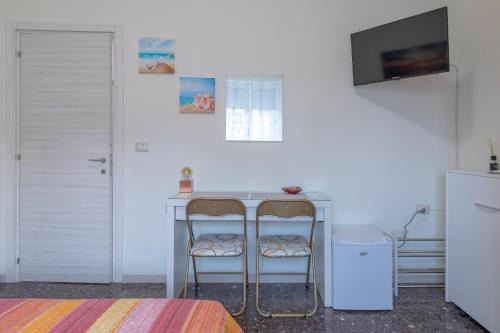 a room with a table and two chairs at Affittacamere SS. Smile in Loreto