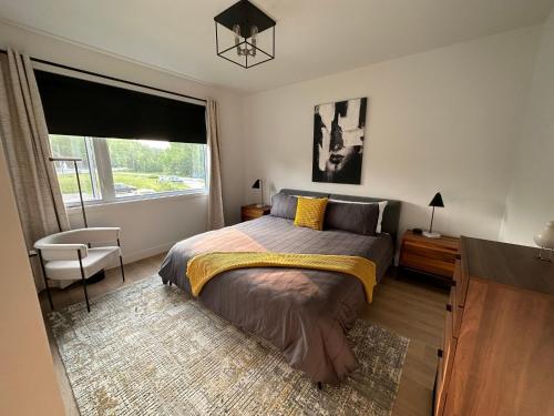 a bedroom with a large bed and a window at Le Joford in Orford
