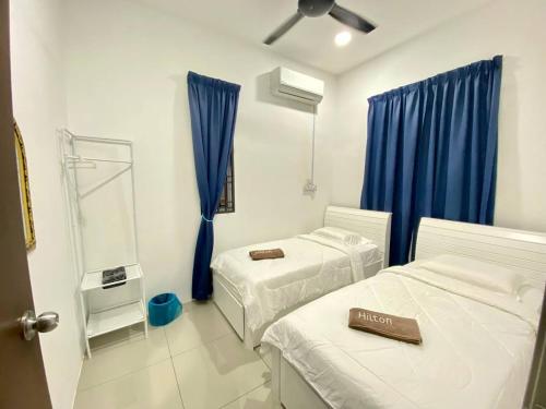Ліжко або ліжка в номері Rumah Inap Che'Gu Baha