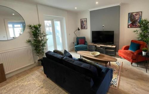 a living room with a couch and a table at Shotley Bridge Blackhill - Stylish and Spacious 4 Bedroom 3 Bathroom Townhouse in Consett