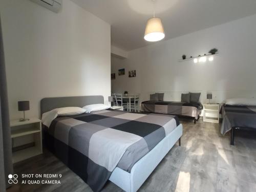 a bedroom with a bed and a couch and a table at Fontanarossa Airport Sleep and Travel in Catania