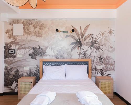 a bedroom with a bed with a mural of plants at Sığacık Gaea Hotel in Izmir