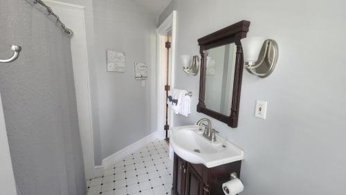 a white bathroom with a sink and a mirror at Greystone Manor Bed & Breakfast in Bird in Hand