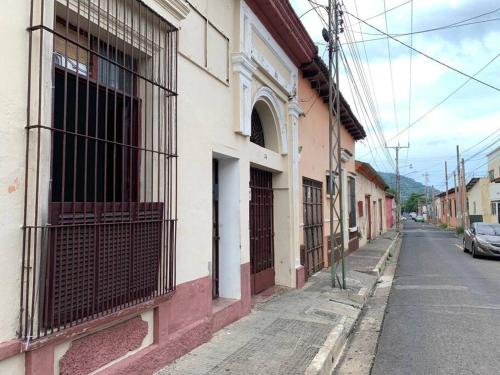 an alley with a building with a gate on the side of a street at "La Casa del Abuelo" in Santa Ana