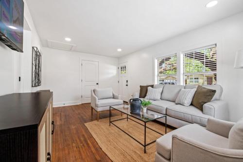 a living room with a couch and a table at Saints Street Charmer in Lafayette