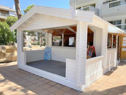 a small white building on a patio at Rentalmar Blue Beach & Pool in Salou