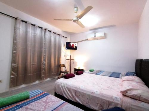 a bedroom with a bed and a flat screen tv at Remember Py in Luque