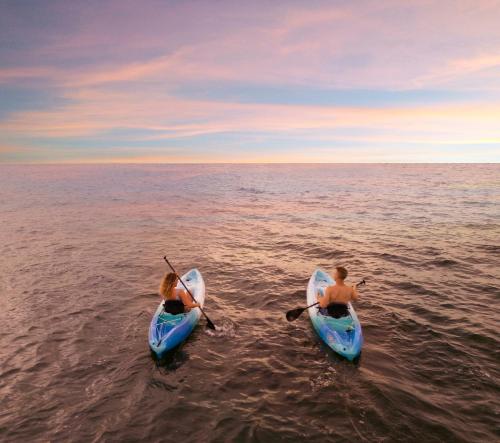two people in kayaks in the water at Bungalows Key Largo - All Inclusive in Key Largo