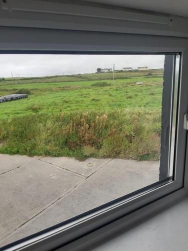 a view of a field from a window at Clare's Cottage in Miltown Malbay