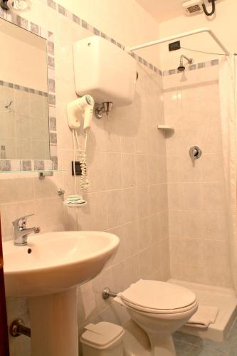 a bathroom with a white toilet and a sink at La Terrazza Di Montepulciano in Montepulciano