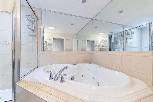 a large bathroom with a tub and a large mirror at 79 Covered Bridge Lane in Bartlett
