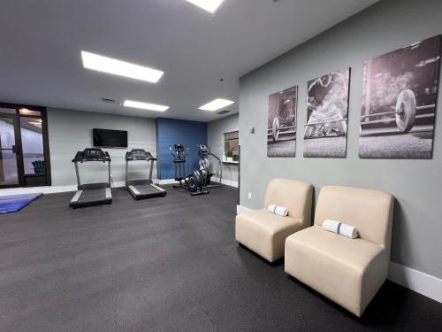 a gym with two chairs and exercise equipment on a wall at Hotel Universel Montréal in Montréal