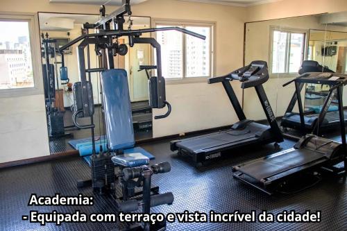 a gym with several tread machines in a room at Residencial Bella Vista Suites in Sao Paulo