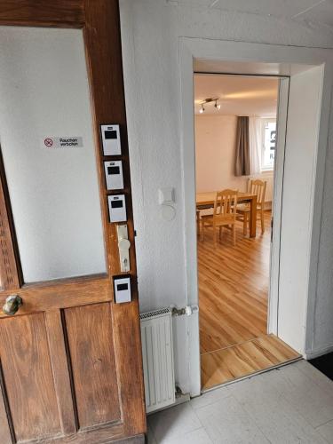an open door to a room with a dining room at B76, Lauterach, Vorarlberg Apartments in Lauterach