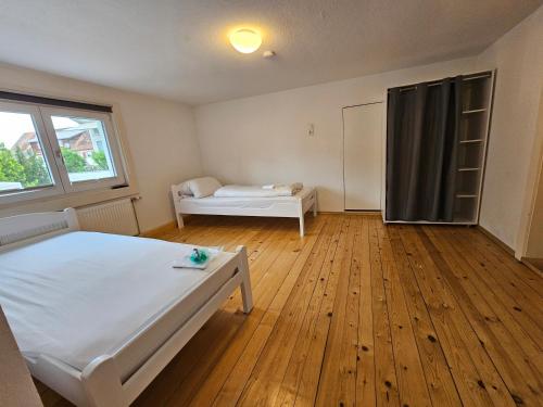 a bedroom with a white bed and a window at VlbgApart Lauterach Bu76 in Lauterach