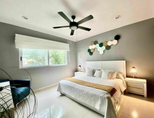 a bedroom with a bed and a ceiling fan at Caribe Grand Dream in Playa del Carmen