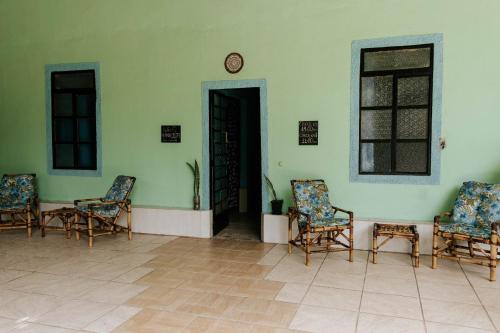 a room with chairs and a clock on the wall at Regenera Gaia in Betim