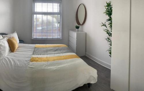 a white bedroom with a bed and a mirror at Shotley Bridge - Large Stylish 3 Bedroom Apartment in Consett