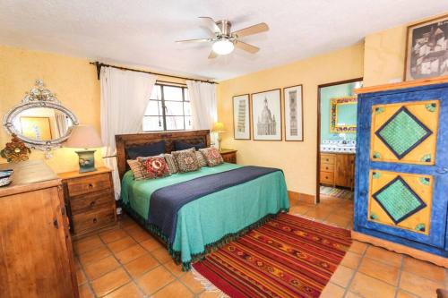 a bedroom with a bed and a ceiling fan at Home in San Miguel de Allende. Casita de La Aldea in San Miguel de Allende