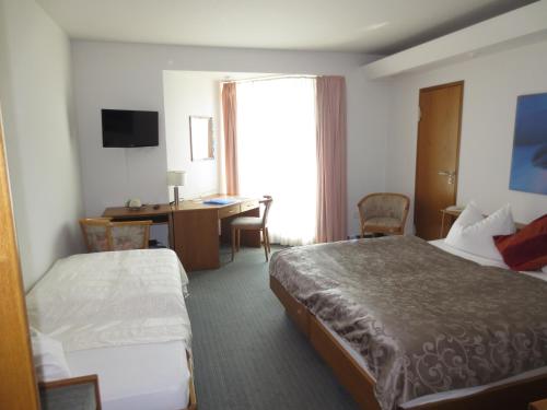Postel nebo postele na pokoji v ubytování Hotel Corsten