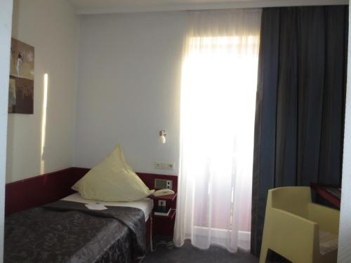 Postel nebo postele na pokoji v ubytování Hotel Corsten