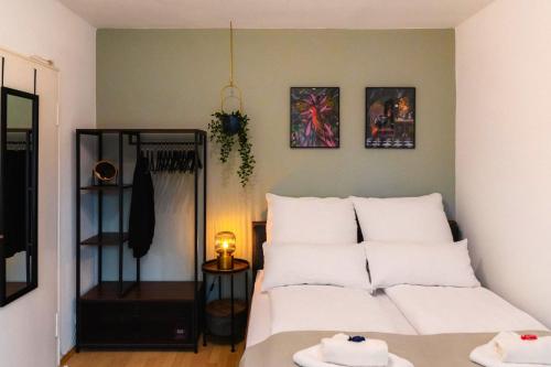 a bedroom with a bed with white pillows on it at Apartment, Free Parking, Netflix in Bocholt