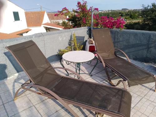 a pair of chairs and a table on a patio at Chapim Azul Studio in Cabrela