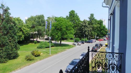 a view of a street from a balcony of a building at Hostel Levicki in Slavonski Brod